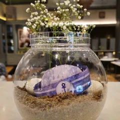 Another version of the sailor-themed centerpiece, this time featuring a miniature sailor hat inside the glass bowl.