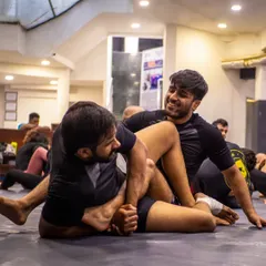 Two students drilling a leg lock submission. The seminar environment is about focused learning and helping your training partners improve.
