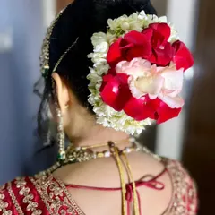 I love using a mix of flowers. This bridal bun features red, pink, and white roses, creating a beautiful, multi-dimensional look from the back.