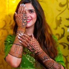 A happy bride is my best advertisement. Here you can see how the full-arm mehndi looks with the bridal outfit, creating a complete and stunning look for your wedding photos. The design features intricate jaali work and floral patterns.