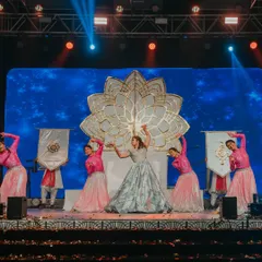 The bride takes center stage for her solo Sangeet performance. The custom-designed lotus backdrop and professional stage lighting created a theatrical and captivating setting for her dance.