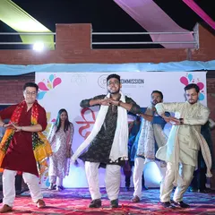 A choreographed team dance performance on stage. I can help organize entertainment and activities that encourage team building and participation.