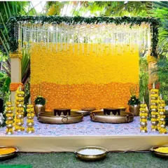 A Haldi ceremony is all about vibrant yellows and joyful celebration. I design classic Haldi stages using walls of fresh marigolds and traditional brass urlis, creating the perfect sun-kissed setting for your pre-wedding rituals.