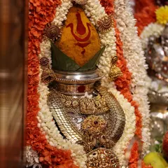 A close-up of the decorated kalasha, which is the heart of the Varamahalakshmi pooja. I guide you on how to adorn it with a turmeric-smeared coconut, mango leaves, and sacred jewelry.