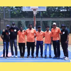 Our coaching staff taking a moment together on the court. The bond between our coaches is the foundation of our academy's leadership.