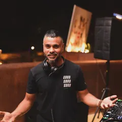 A welcoming pose from behind the decks. I'm always approachable and ready to connect with the crowd and take their energy to the next level.