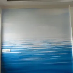 An abstract seascape mural that creates a sense of calm and openness. The gradient from deep blue to a light sky makes the room feel larger and more serene.