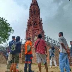 Sharing stories is what we do best, whether on a cycle tour or a walking tour. Here, our guide captivates a group with tales of a historic Christian monument in Delhi.