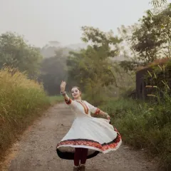 Capturing the grace of movement is a passion of mine. Here, a Kathak dancer is captured mid-twirl on a rustic path, her costume flowing against the soft, misty backdrop. This outdoor dance portrait combines elegance with the beauty of nature.