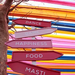 Custom signage points the way to 'Dance, Game, Happiness, Food, Masti', setting a fun and festive tone for the celebration.