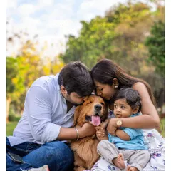 This is what pure happiness looks like. A beautiful family enjoying a sunny day in the park, with their golden retriever Scotch right in the middle of the group hug. My goal is to capture this casual, fun, and warm chaos that makes your family unique.