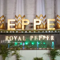 A close-up of the venue's branding and decor, featuring illuminated letters and a water feature. These details add to the unique character of the event.