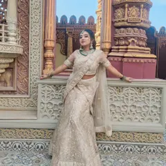 A full-length view of the client in her beautiful embroidered lehenga. The makeup and hair are styled to create a cohesive and regal look, suitable for a grand wedding or reception.