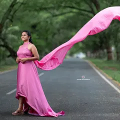 This pink rental gown features a beautiful high-neck textured top and a long, flowing trail that catches the wind perfectly for dynamic shots.