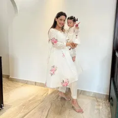 Twinning in elegant white. This mother-daughter duo is wearing custom hand-painted floral kurta sets, perfect for a puja, family gathering, or any daytime occasion.