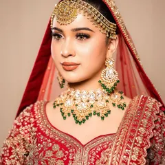 A three-quarter profile of our bride, highlighting the contouring and the intricate matha patti. The makeup is set to perfection, ensuring it looks stunning from every angle throughout the wedding day.