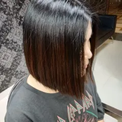 The classic bob haircut requires precision and an eye for detail. Here, we've created a sharp, clean line that enhances the jawline and provides a timeless, chic look that is easy to manage.