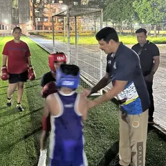 A moment of instruction before a sparring drill. I ensure every young boxer understands the task and the technique, providing guidance to keep them safe and help them improve.