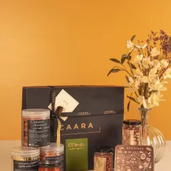 This Rakhi hamper features a selection of our savoury jars and Bruijn's gourmet treats, presented in our signature black gift box. It's a sophisticated gift that combines the best of both brands.