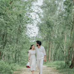 A quiet walk through a wooded path. We capture the simple, intimate moments of togetherness that make your love story unique.