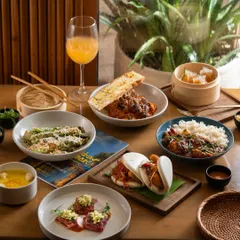 An elegant Asian meal for one, styled with natural light by a window. This creates a calm and sophisticated dining atmosphere.