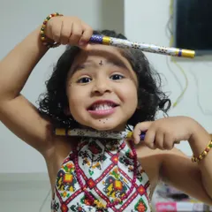 Our little princess ready for Garba night. This close-up shows her playful expression and the traditional print of her custom choli, perfect for kids' festive wear.