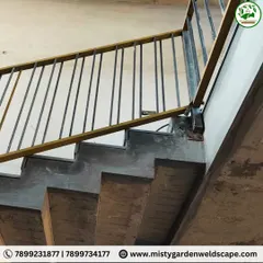 A close-up of the staircase railing's mounting point. I ensure every connection is securely welded and finished to provide a safe and sturdy structure that you can rely on.
