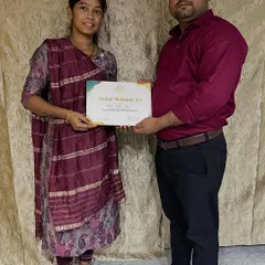 Presenting a certificate of completion to a dedicated student. Seeing them ready to take on professional work is my biggest reward as a teacher.
