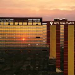 The Rupa Renaissance IT park in Navi Mumbai is captured here at sunset, with its distinctive facade reflecting the sky. This project exemplifies our focus on sustainable design, utilizing solar energy and optimal building orientation to create an energy-efficient commercial space.