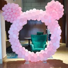 A fun and creative Mickey Mouse-shaped balloon arch in all pink. This unique frame is perfect for a Disney-themed party and serves as a fantastic photo booth.