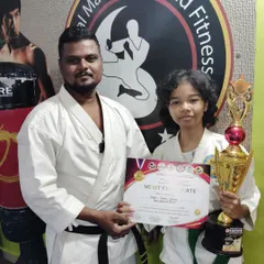 Posing with a young karate champion from our academy. Her success in competition is a proud moment for our entire team.