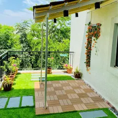 Another view of the bright balcony garden, showing how the potted plants along the railing add color and life. The space is designed to be a safe and enjoyable play area for a small child.