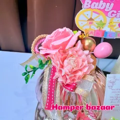 A close-up of the floral details and ribbons on our pink baby girl hamper.