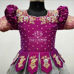 This close-up shows the detailed floral maggam work and pearl accents on a magenta blouse, set against puff sleeves with a Banarasi border.