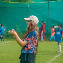 A parent applauds a great play from the sidelines. This support is what fuels the players' confidence.