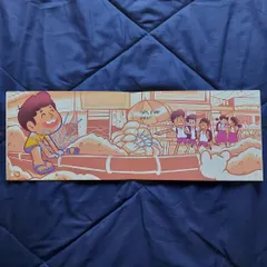 A full spread illustration from the book 'Karanje'. This scene shows the main character playing near a leaking water pipe, a common childhood memory for many.