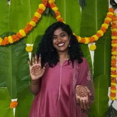 A happy bride showcasing her minimal mehendi. This design focuses on a simple yet elegant mandala on the palm, perfect for a subtle bridal look.