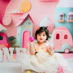 A calmer moment during the city-themed shoot. She sits sweetly amidst the colorful props, giving a lovely, gentle portrait.