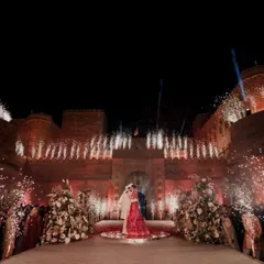 A moment suspended in time. Against the majestic backdrop of Suryagarh, we framed the couple's union with a symphony of light and fireworks, creating a magical embrace that sealed their love story forever.