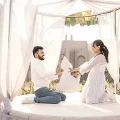 A fun and energetic pillow fight in a beautiful white tented set. I love capturing these playful moments that show the joyful side of your relationship.