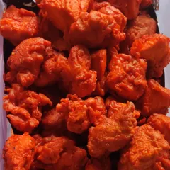 Our crispy and soft Chicken Kababs, a timeless party favorite. These bite-sized pieces are marinated in a vibrant red masala and fried to be juicy on the inside and perfectly crisp on the outside.
