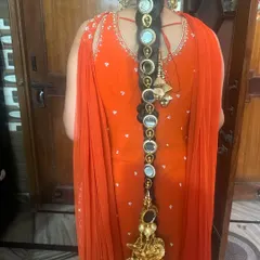 A full back view of the parandi braided into the hair, showing its length and the beautiful tassel at the end.