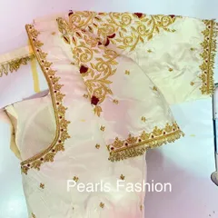 A classic bridal blouse in off-white silk with gold Zari and red threadwork. I focus on making the embroidery look full and neat, especially on the sleeves and neckline.