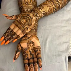 A close-up of a custom groom portrait on the bride's palm. I work from photographs to capture likenesses, ensuring your most important people are part of your bridal henna.