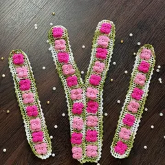 This is one of my custom neckline and sleeve sets, designed to transform a plain kurta or top. The set features intricate pink crochet flowers on a green leafy base, ready to be stitched on for a completely new, designer look.