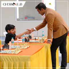 A handshake of sportsmanship between Grandmaster M S Thejkumar and a young participant. We teach our students the importance of respect for the game and their opponents.