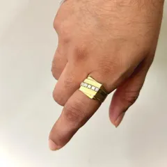 This ring demonstrates a modern approach to men's jewellery. Crafted in solid gold, it features a clean channel setting with a row of diamonds, offering a sleek and sophisticated look on the hand.