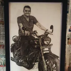 A custom A3 size pencil sketch commission of a client on his motorcycle, framed and ready to be displayed.