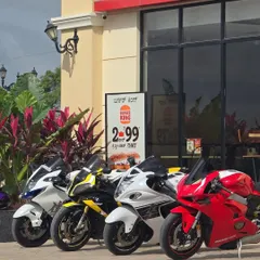 A lineup of superbikes parked outside Burger King. We're the ideal spot for riders to take a break and grab a bite.