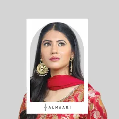 The right earrings can make an entire outfit. Here, a pair of large, traditional gold jhumkas adds the perfect festive touch to a simple red ethnic suit.